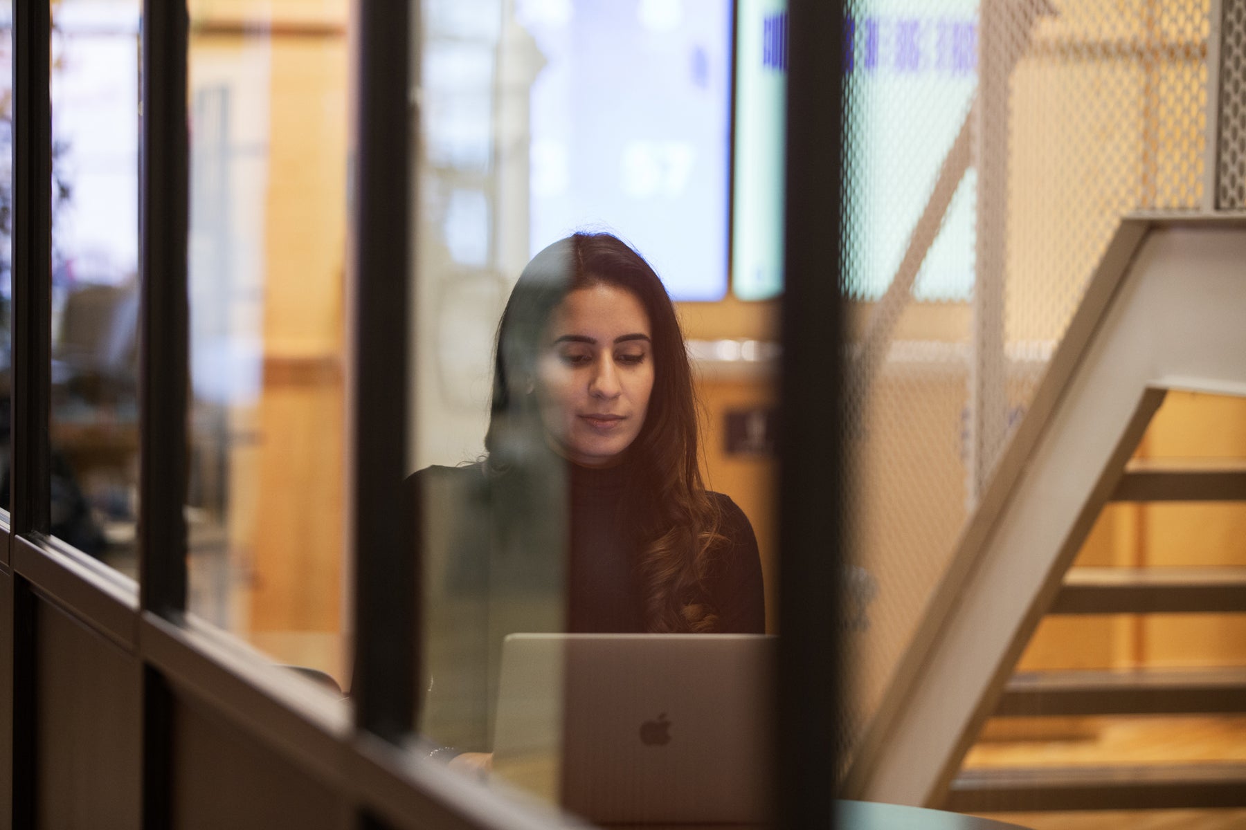 Nimi Kular, co-founder of Jaswant's Kitchen, working on her laptop at Toronto's Shopify office.