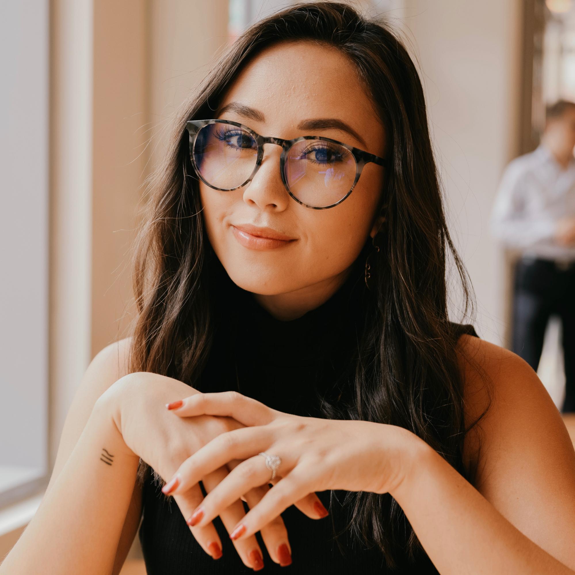 Natalie Rogers, the founder of Klassy Network wearing a pair of blue light glasses. 