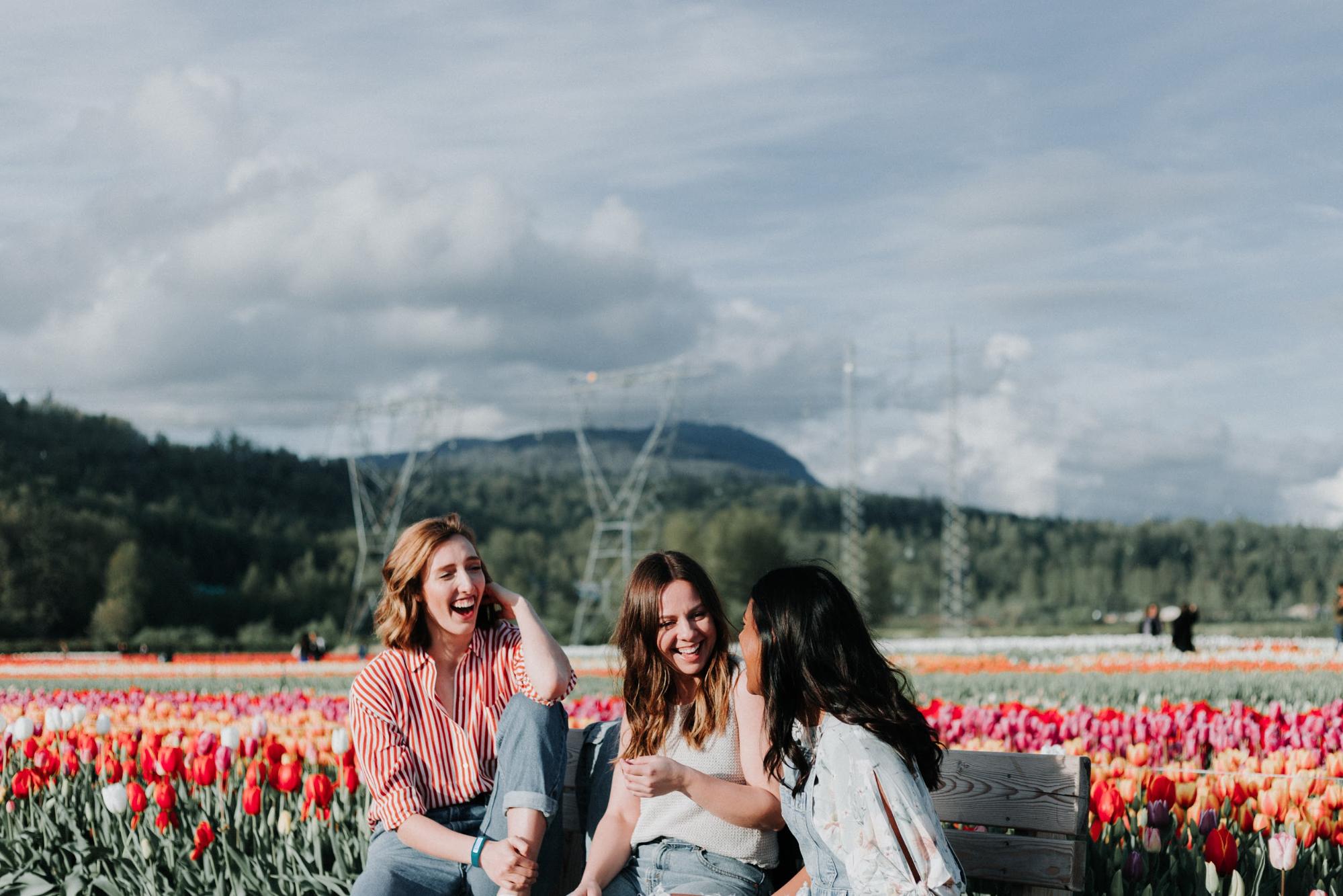 Three models in a field of tulips one of them is wearing a HabitAware bracelet. 