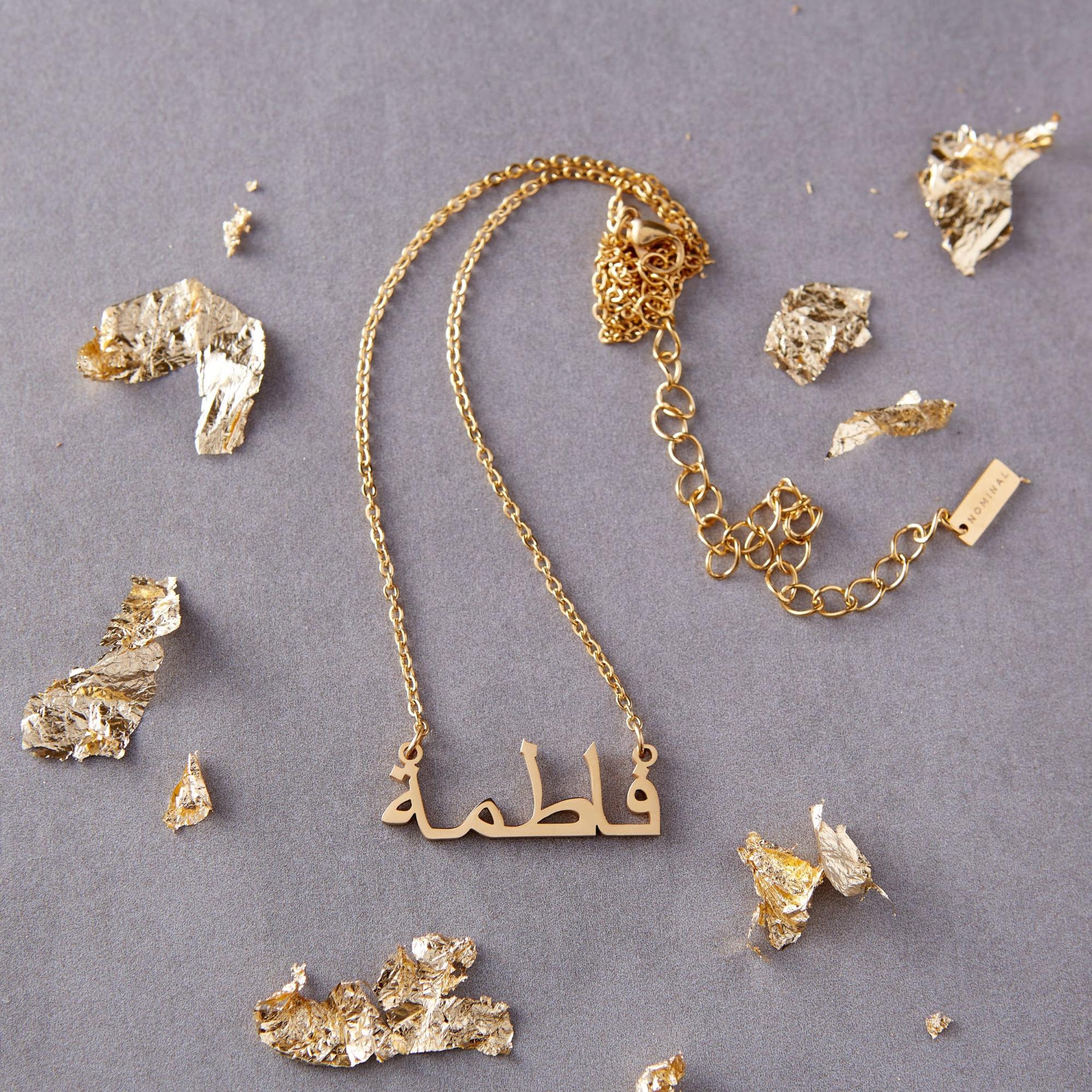 An array of golf foil pieces along with a necklace from Nominal.