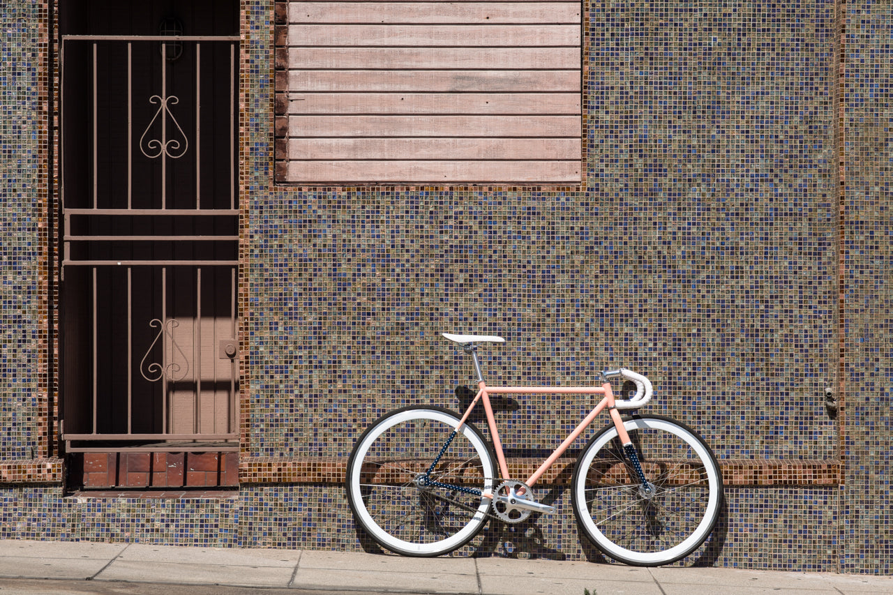 A bike against a concrete wall from State Bicycle Co. 