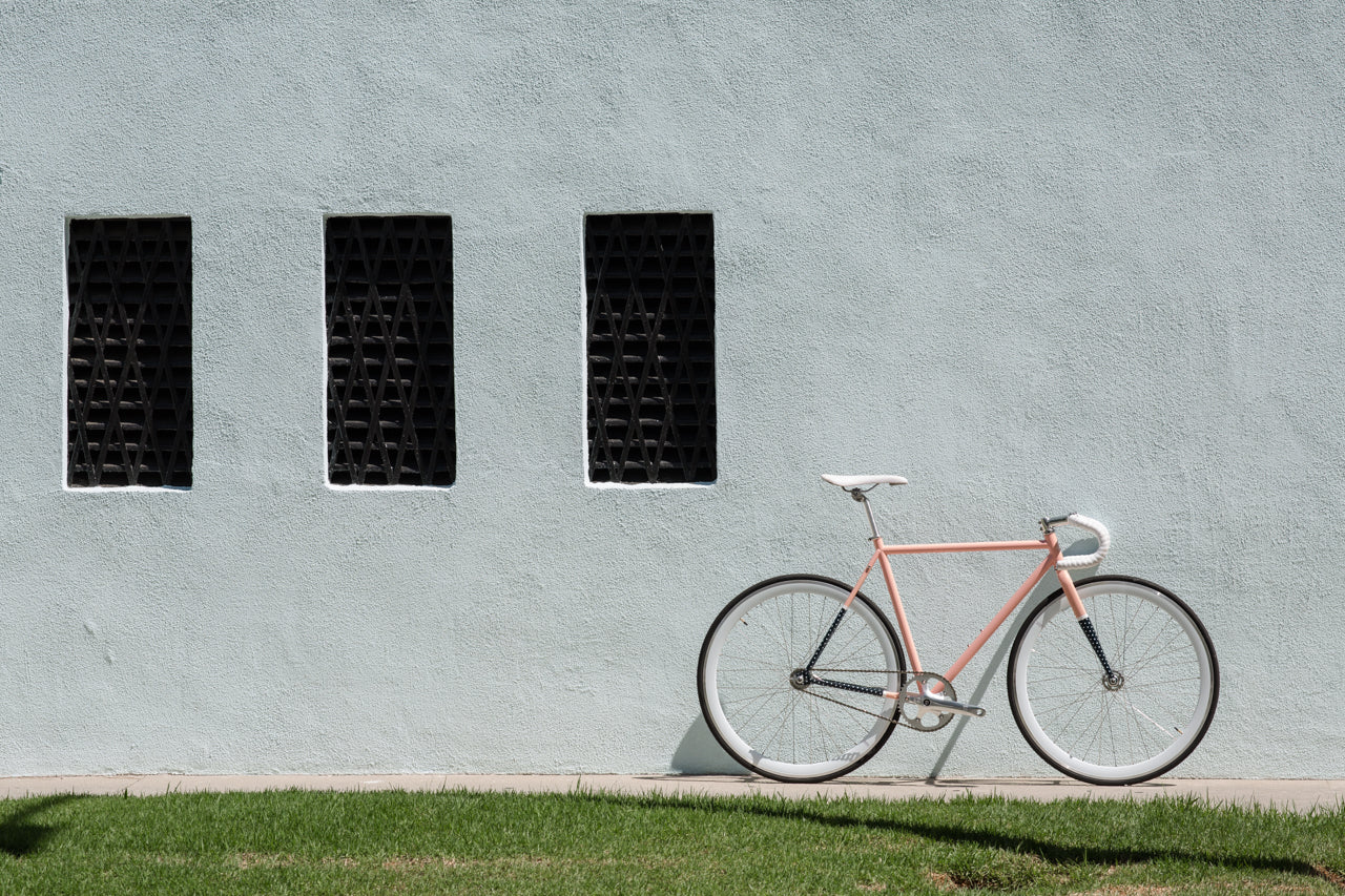 A bike from State Bicycle Co. against a white wall. 