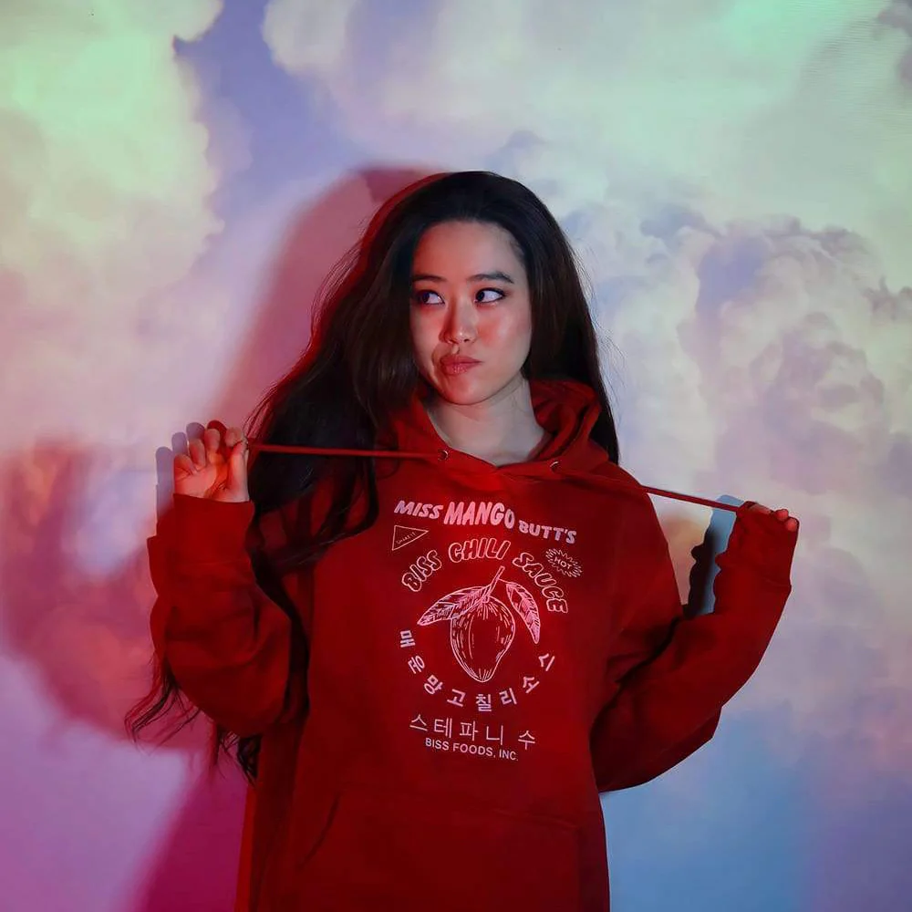 Mukbang star Stephanie Soo wearing her merch of an oversized red hoodie. 