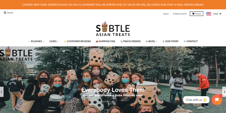 Subtle Asian Treats homepage with menu options and image of customers holding products.