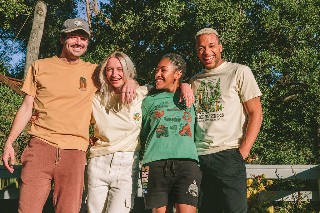 Four young adults wearing Parks Project tees