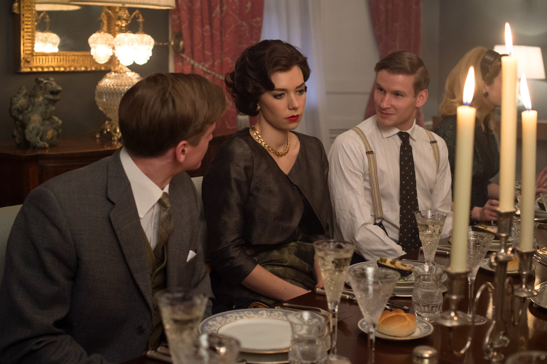 Princess Margaret (Vanessa Kirby) sits uncomfortably between two dinner guests