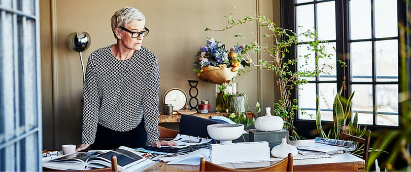 Woman looking at a table full of work