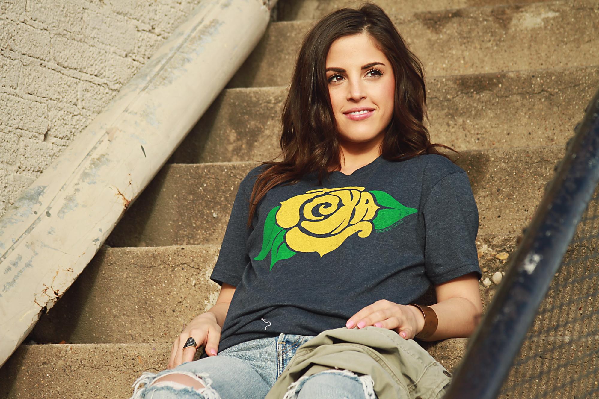 A female model wearing a grey t-shirt by Tumbleweed Texstyles.