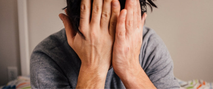 Frustrated man with his hands on his face