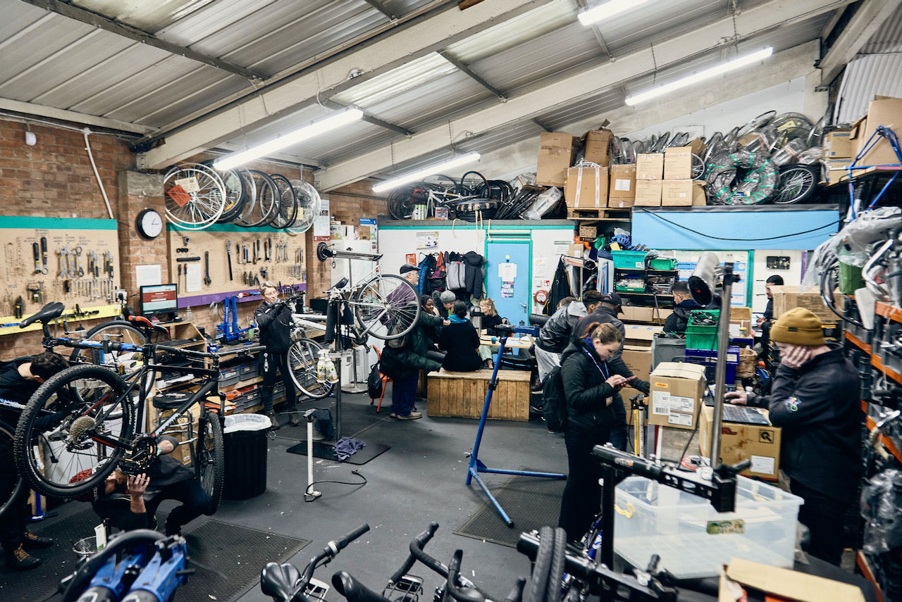 The Bike Project’s workshop filled with customers, volunteers, and mechanics. 