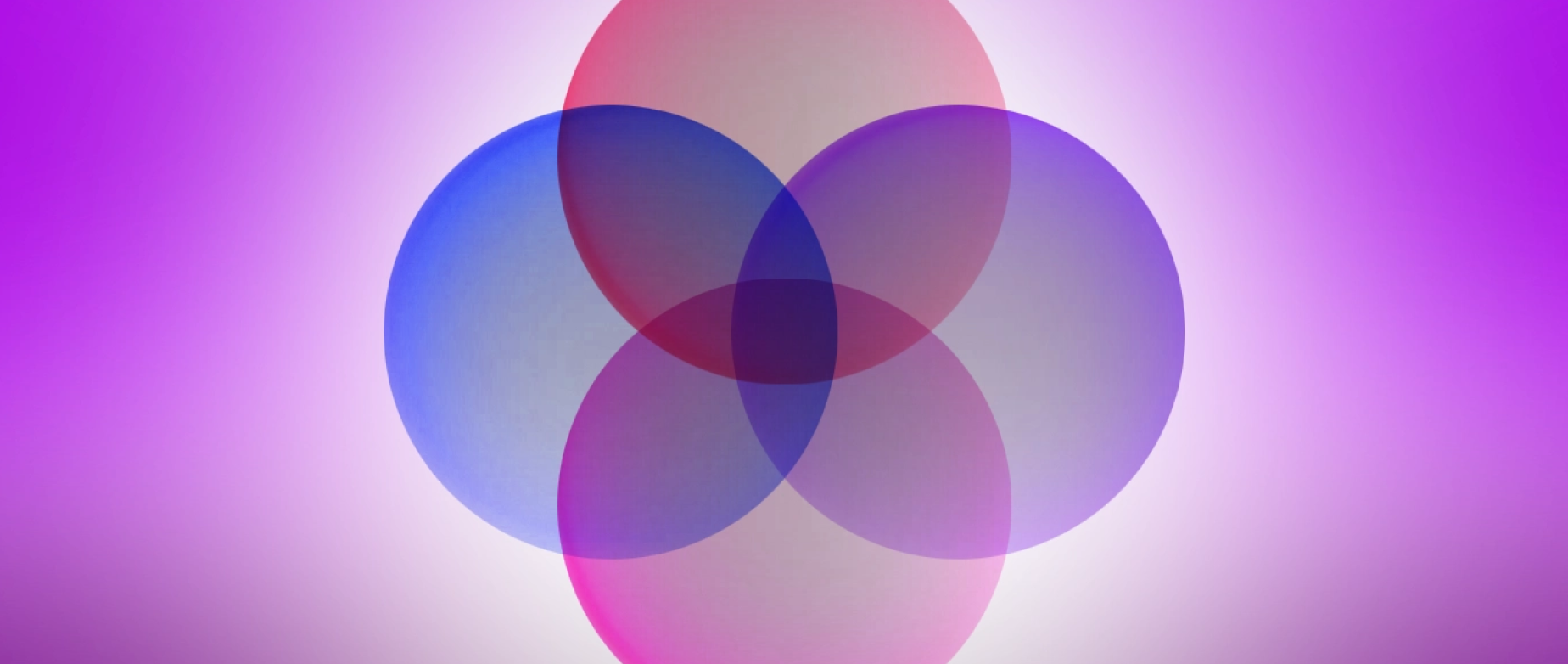 Four overlapping colorful circles on a pink background.