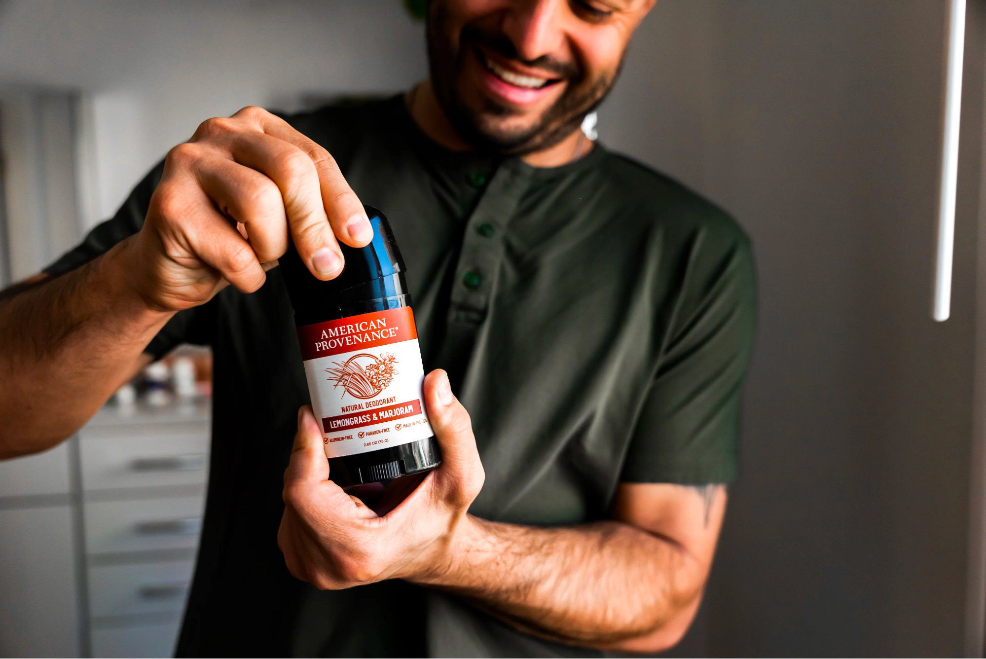 A person holds a trending product, natural deodorant, up to the camera