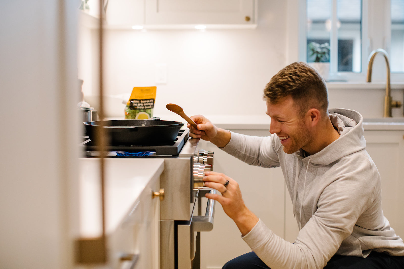 A male consumer of Bluebird Provisions makes bone broth in a kitchen setting.