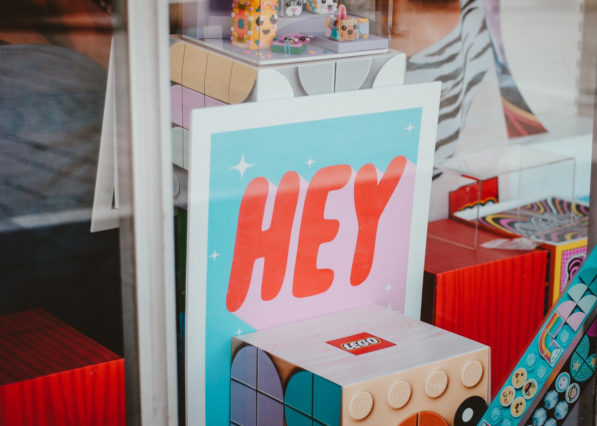 A peek inside a store window at a Lego merchandising display