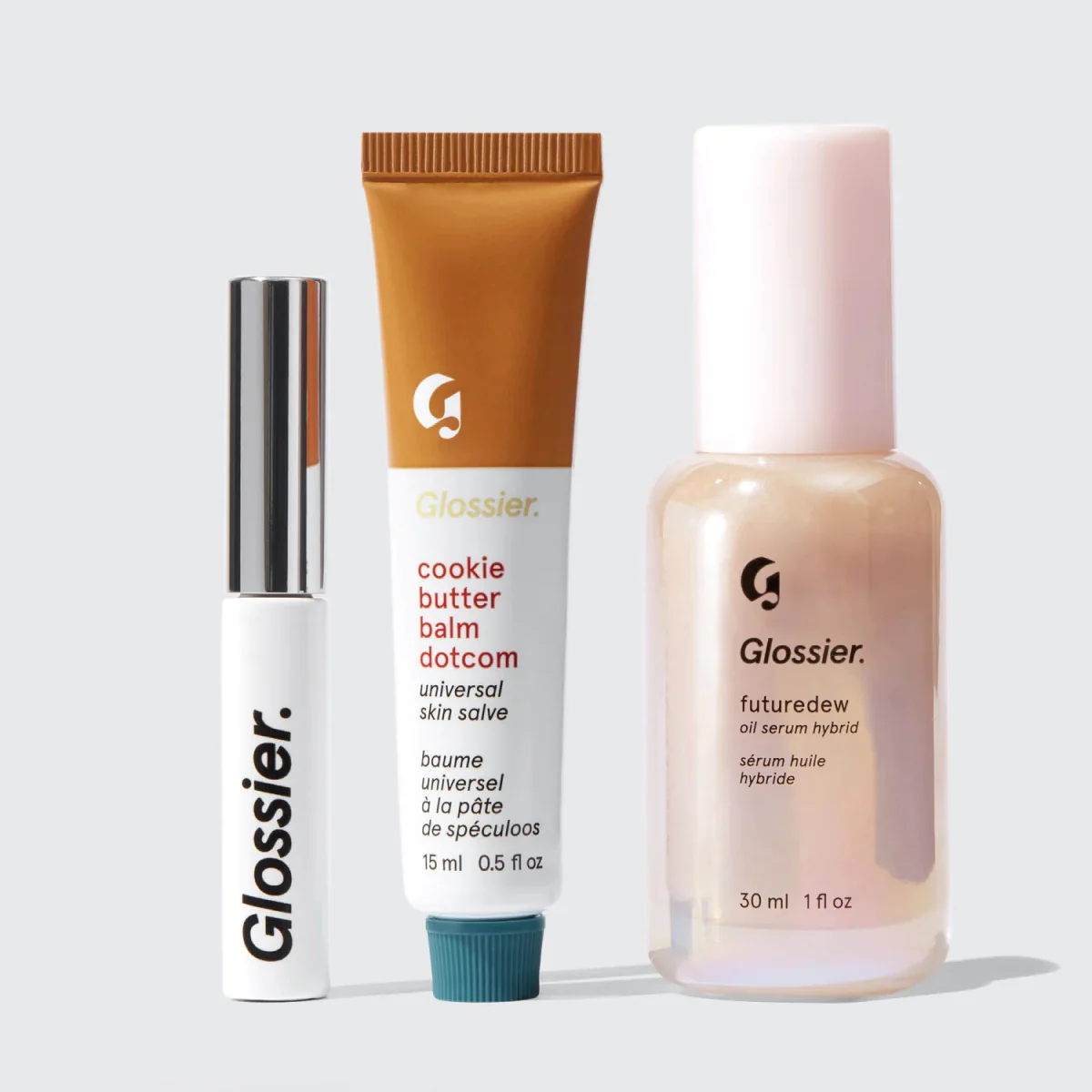 Three glossier products lined up against a plain background