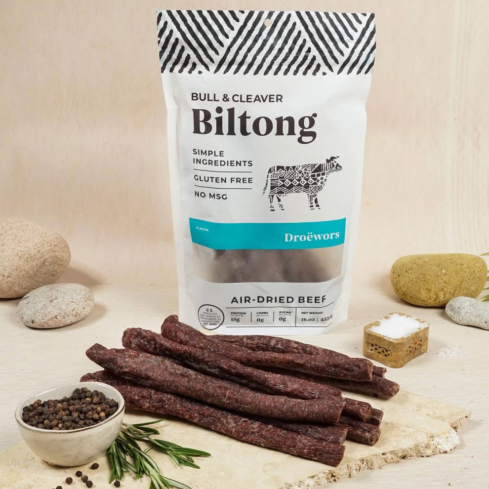A Bull & Cleaver product bag arranged with biltong and other foods