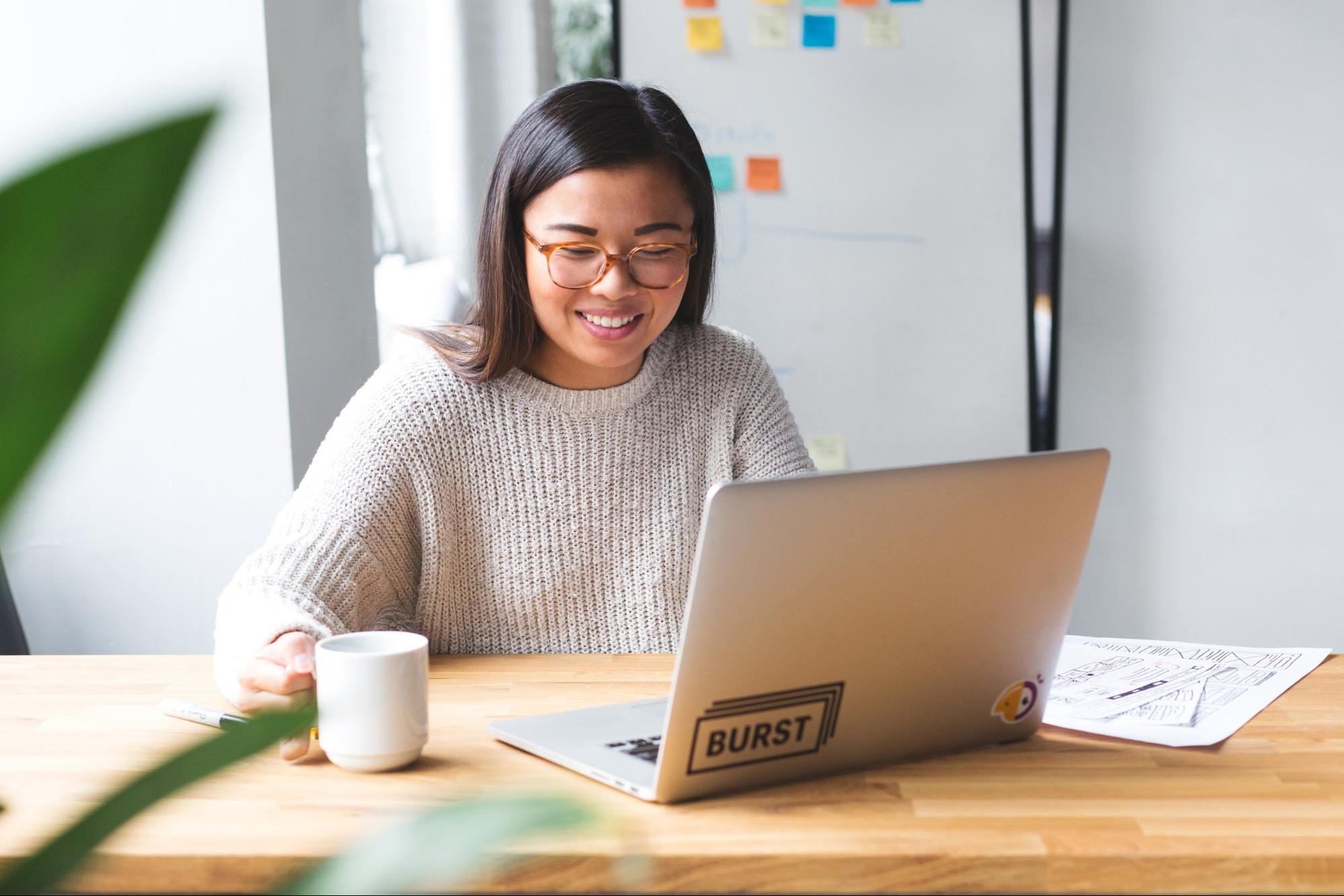 Woman sitting at laptop creating a nonprofit business plan