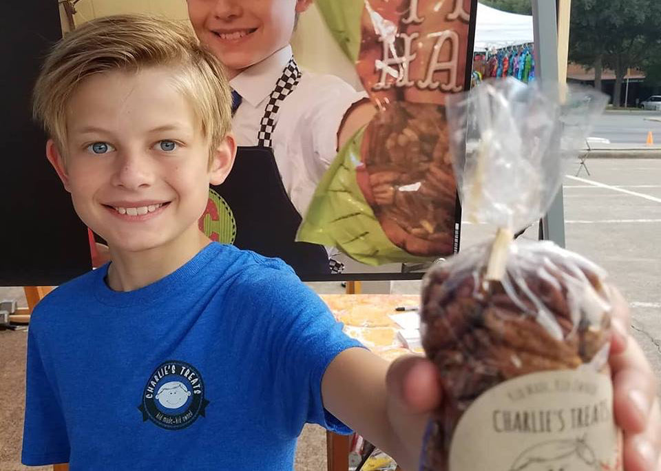 Charlie Kobdish holds out a bag of candied nuts