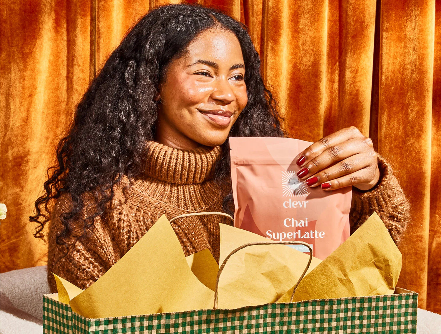 A woman places tea and coffee blends into a tote bag