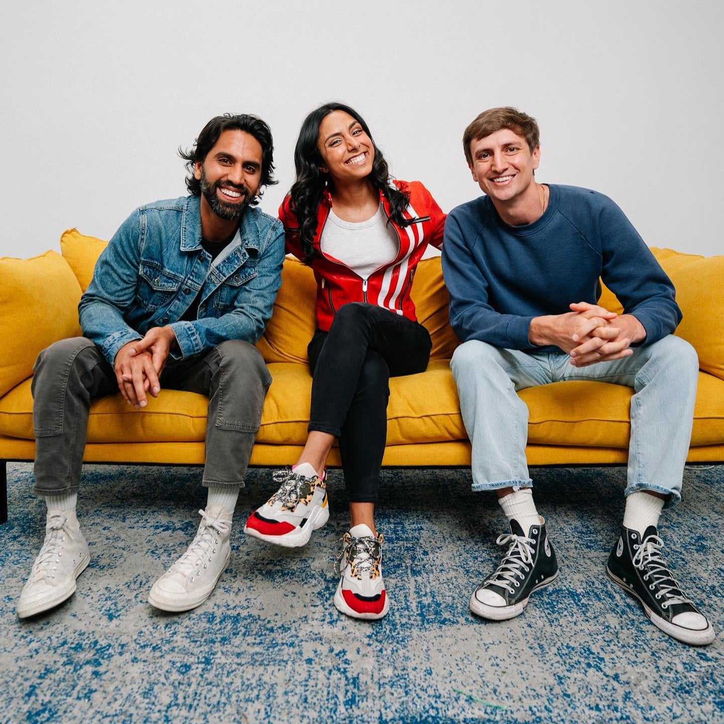 Portrait of three online creators sitting on a yellow couch