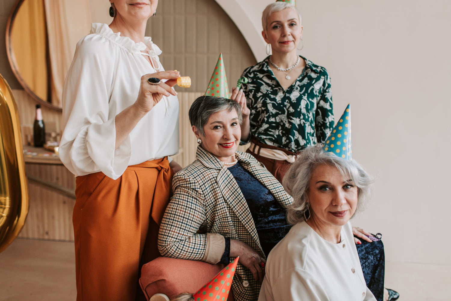 Four older women celebrate a birthday