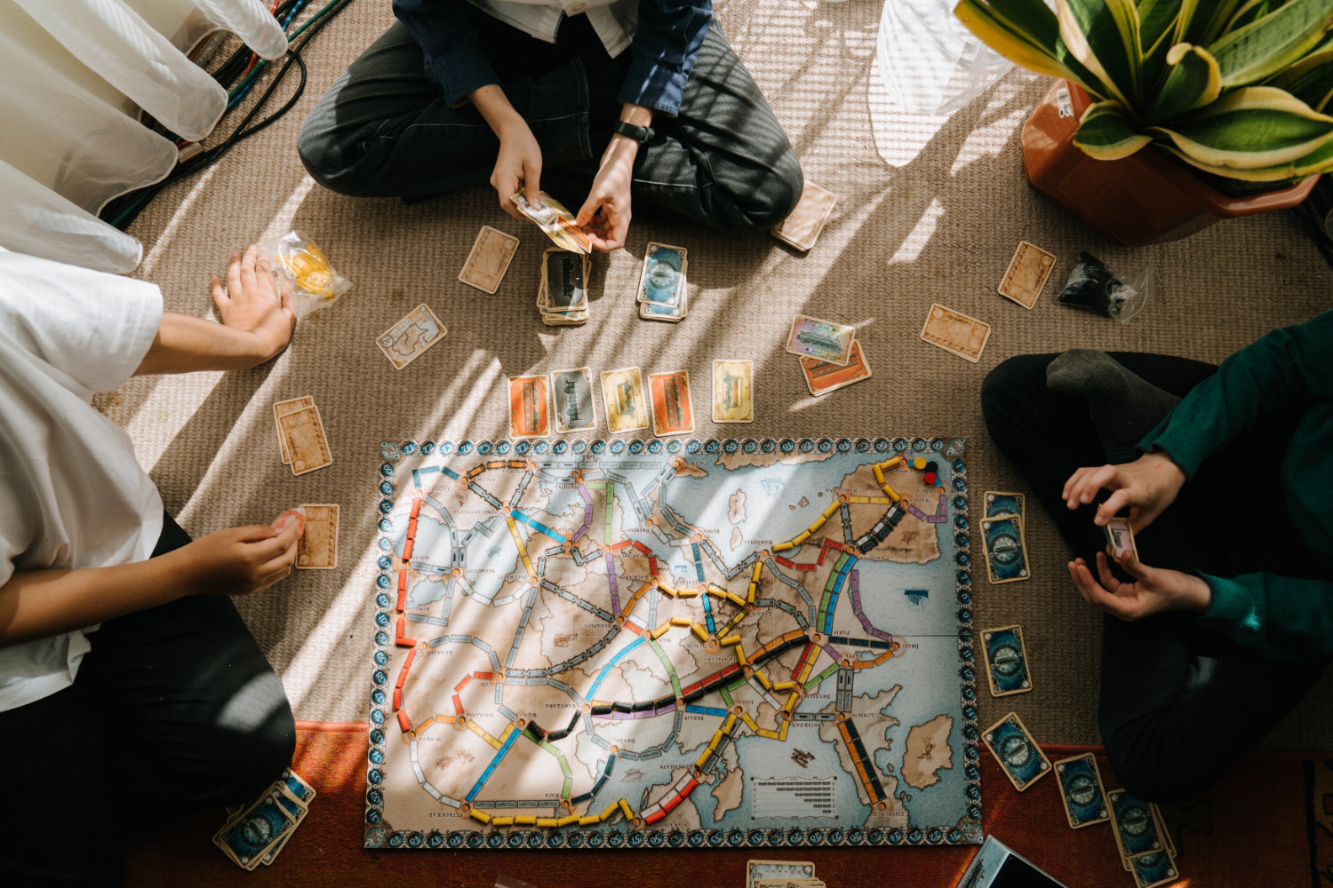 Overhead view of people playing a board game