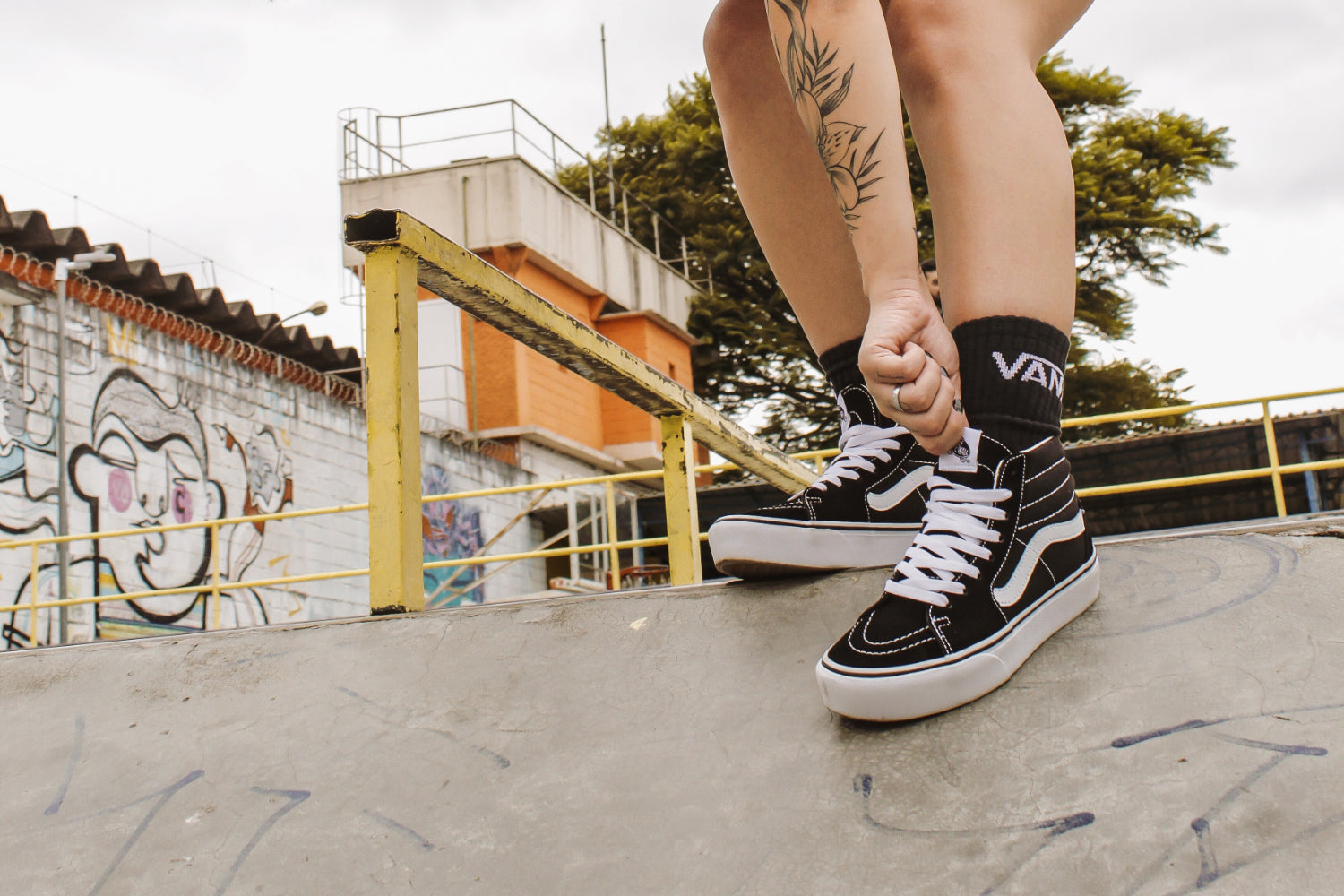 A skater wears Van socks and shoes in a skate park