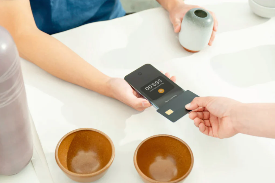 image of customer using Shopify Tap to Pay on iPhone to make a contactless payment