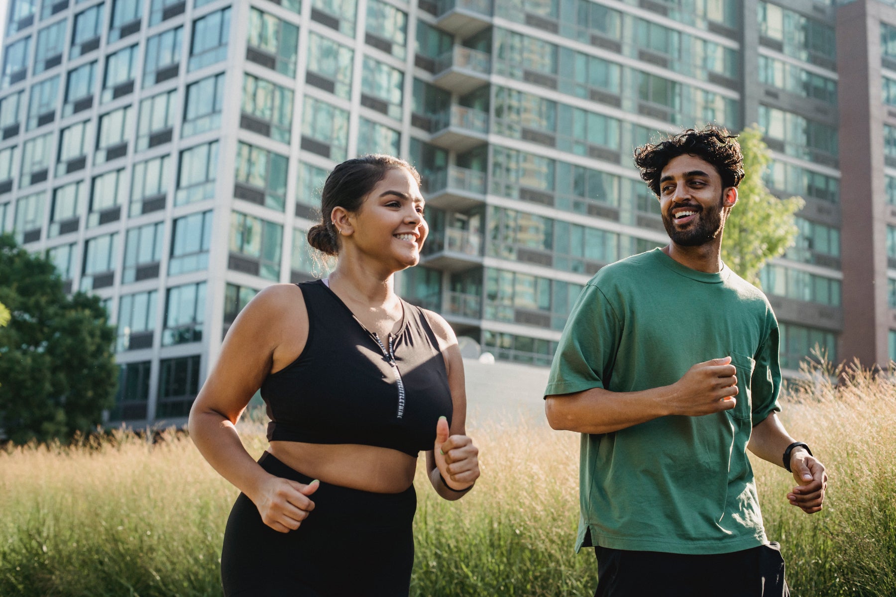 Two people jog together in a city setting