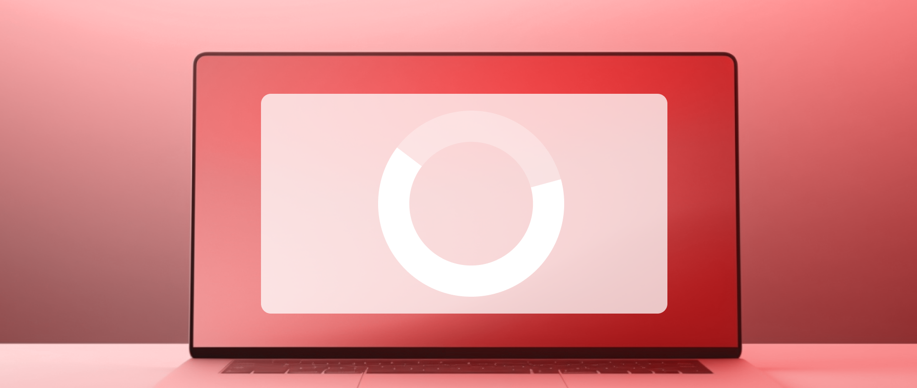 A laptop with a red loading screen on a light red background.