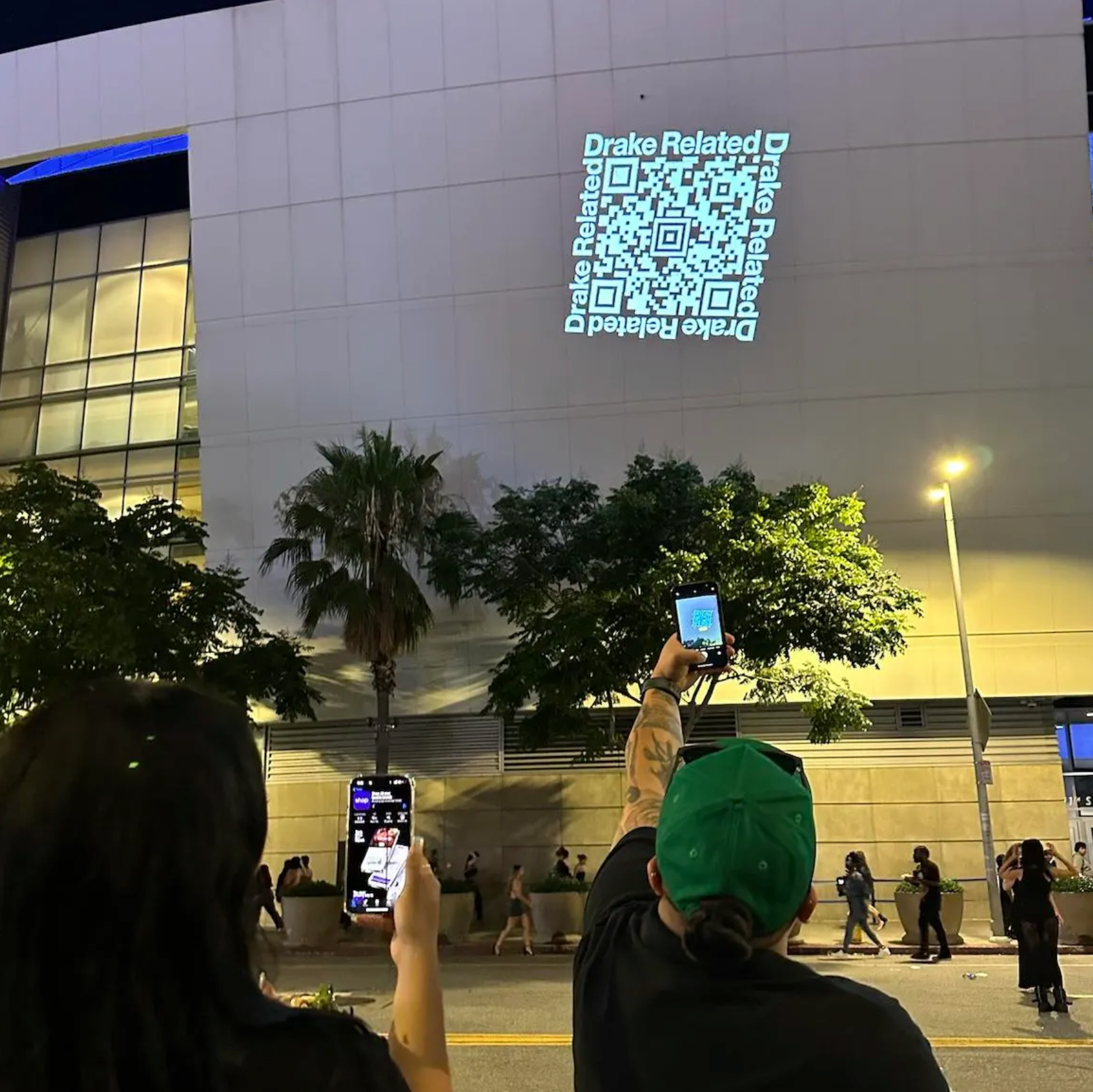 Image of Drake using guerrilla marketing techniques to promote a giveaway to fans after a concert.