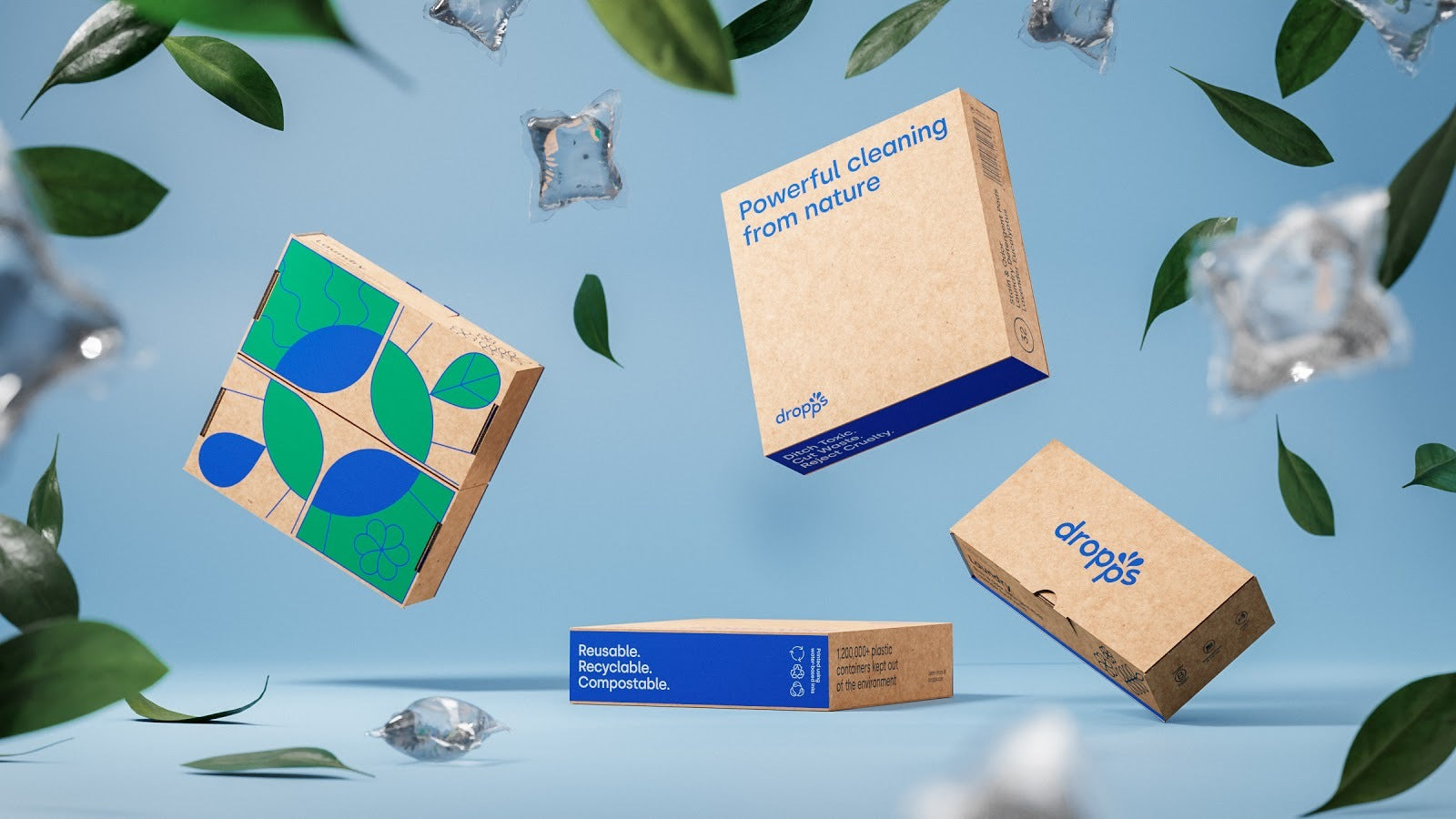 Four dropps packages suspended against a light blue background, surrounded by floating leaves and laundry pods 