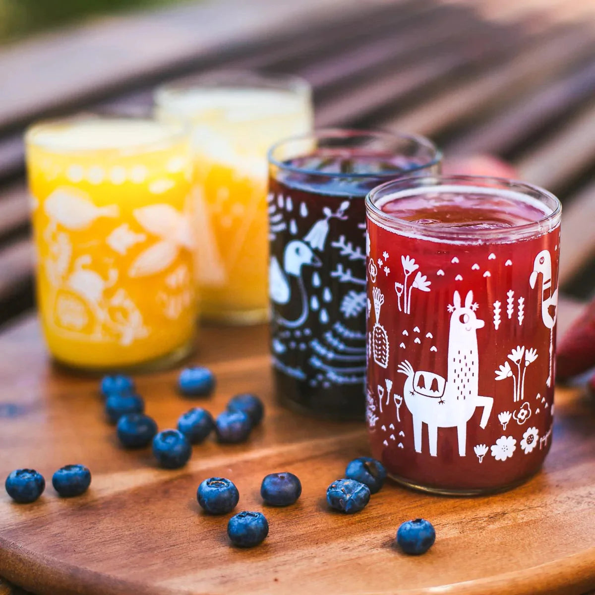 A set of etched glassware containing juice