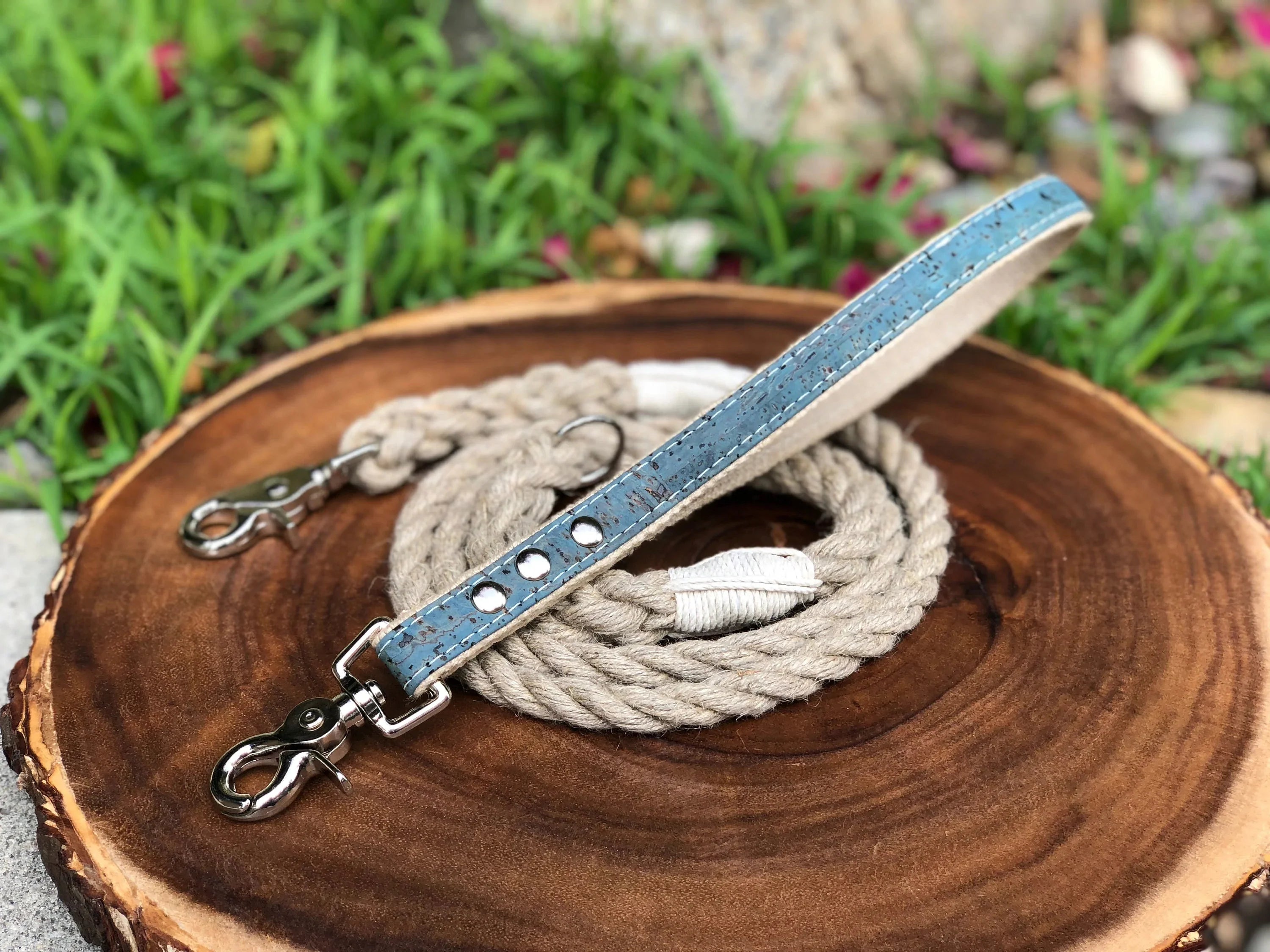 A hemp leash coiled on a wood stump