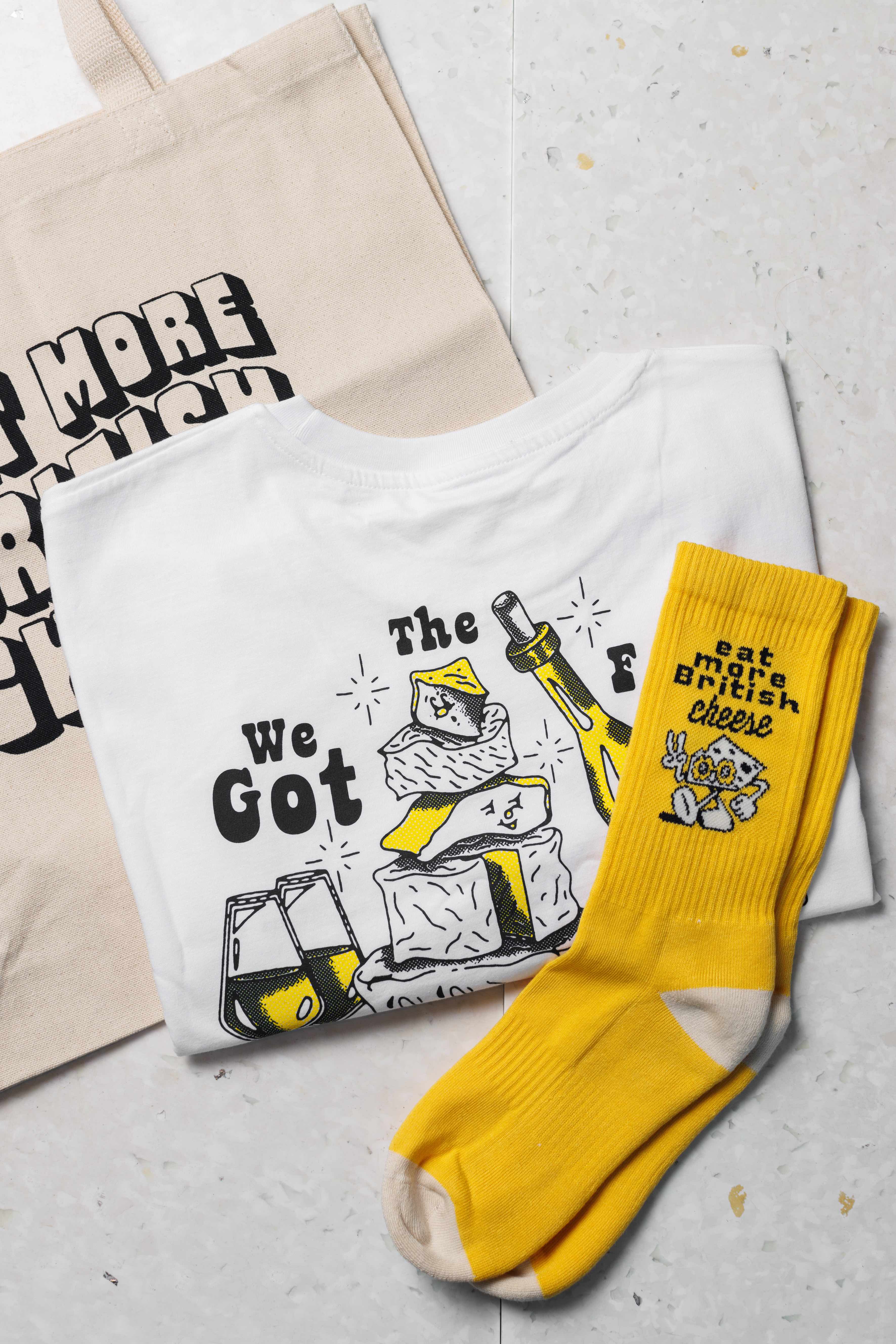 A pair of yellow socks along with a t-shirt and tote bag offered by Funk the online and retail store operated by The Cheese Bar. 