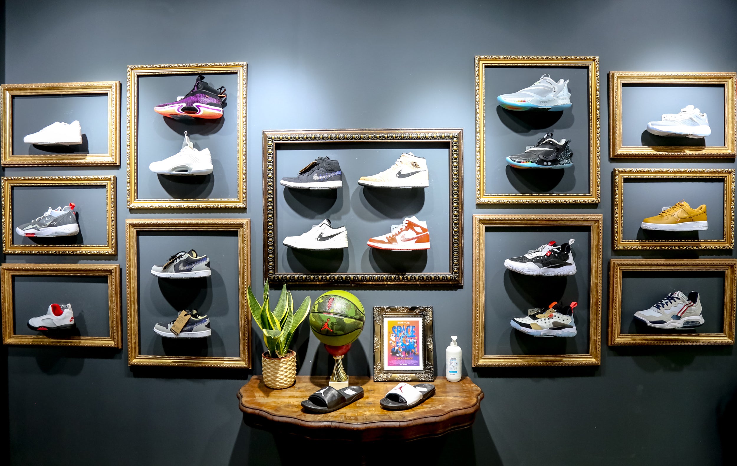 A wall in a retail store featuring several sneakers