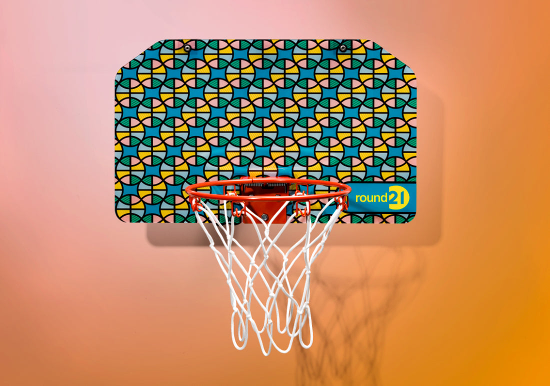 A mini basketball hoop by Round21 against an orange background