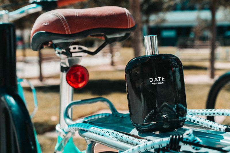 A bottle of Date for Men scent by Fragrance One on the back of a bicycle. 