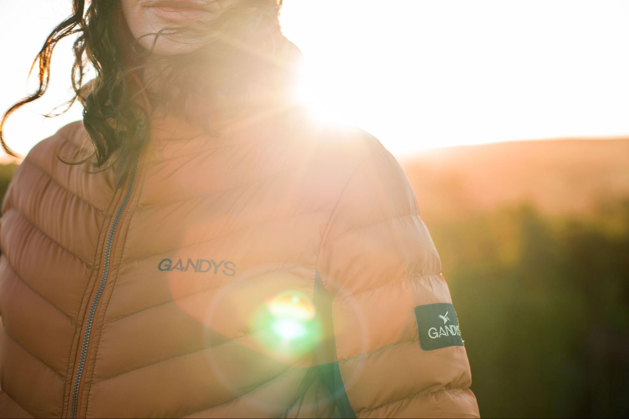 A model wears an orange Gandys jacket. 