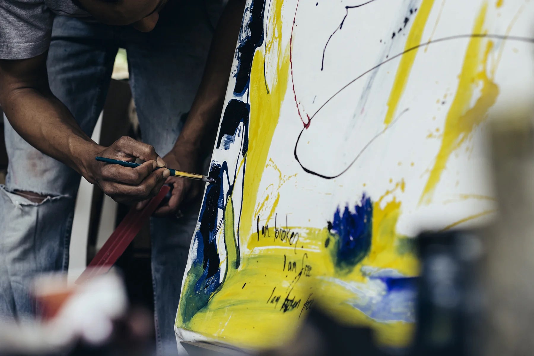 An artist paints a canvas