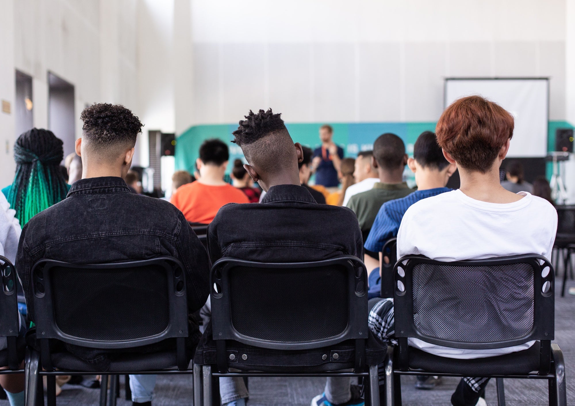 A classroom full of older students, photographed from the rear of the room