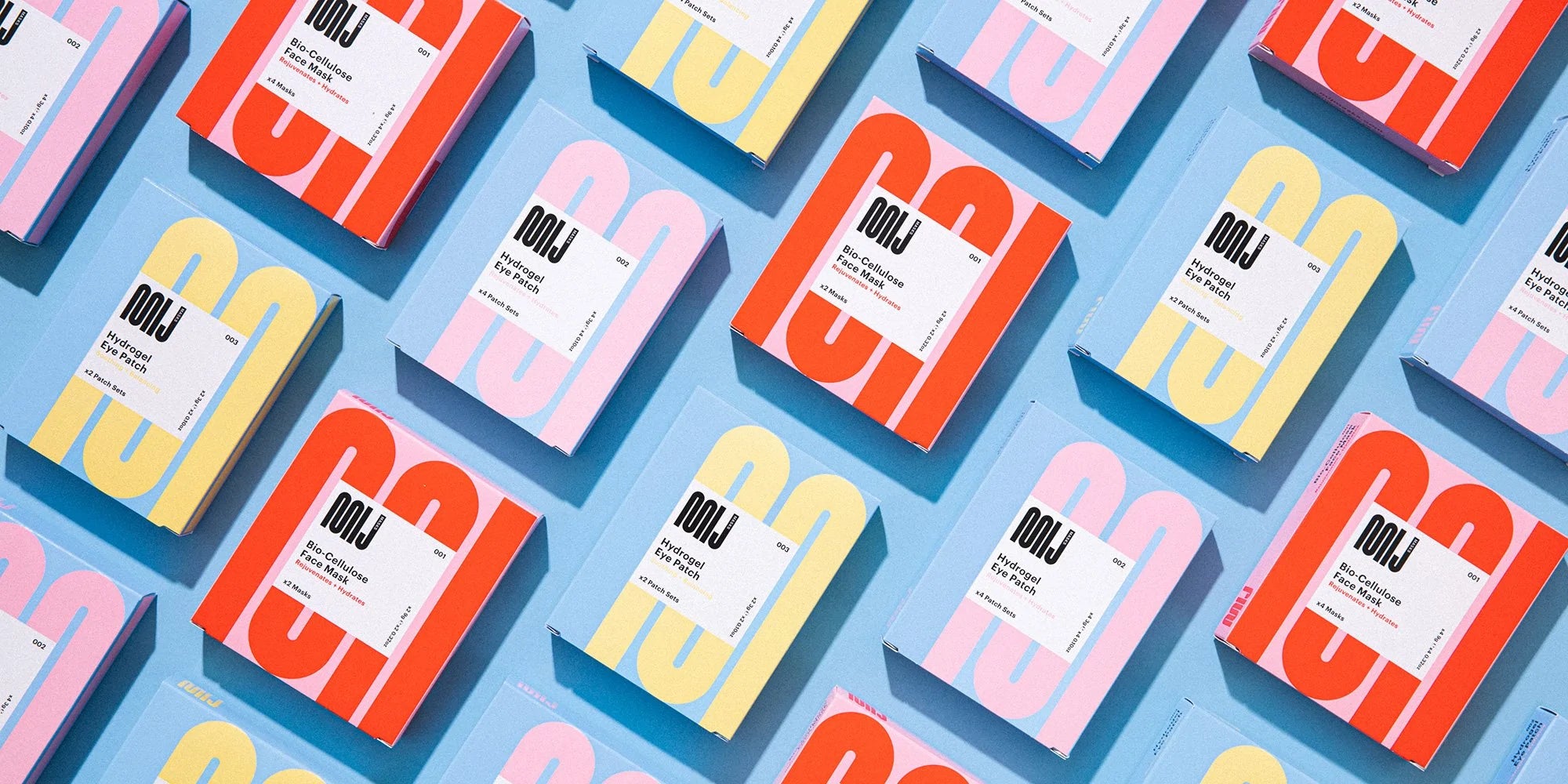 An array of boldly colored boxes branded "MIJ" are lined up on a blue surface