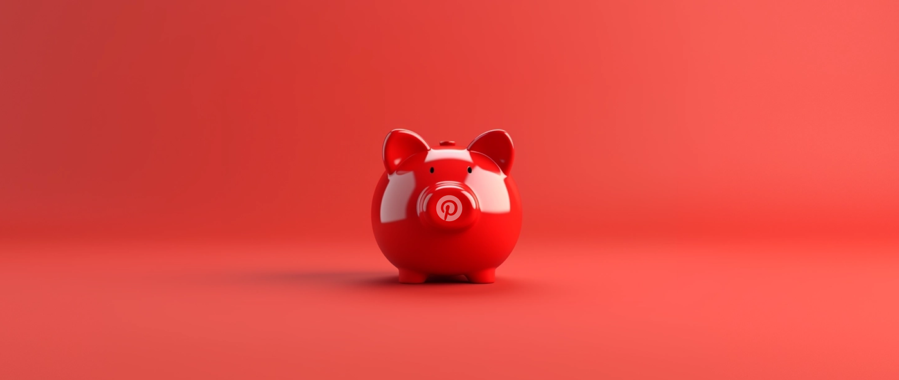 A shiny red piggy bank on a red background.