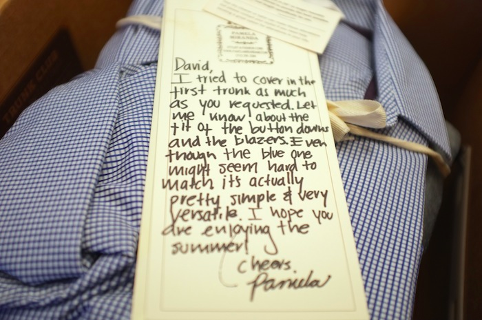 Photo of handwritten thank you note on top of purchased shirt