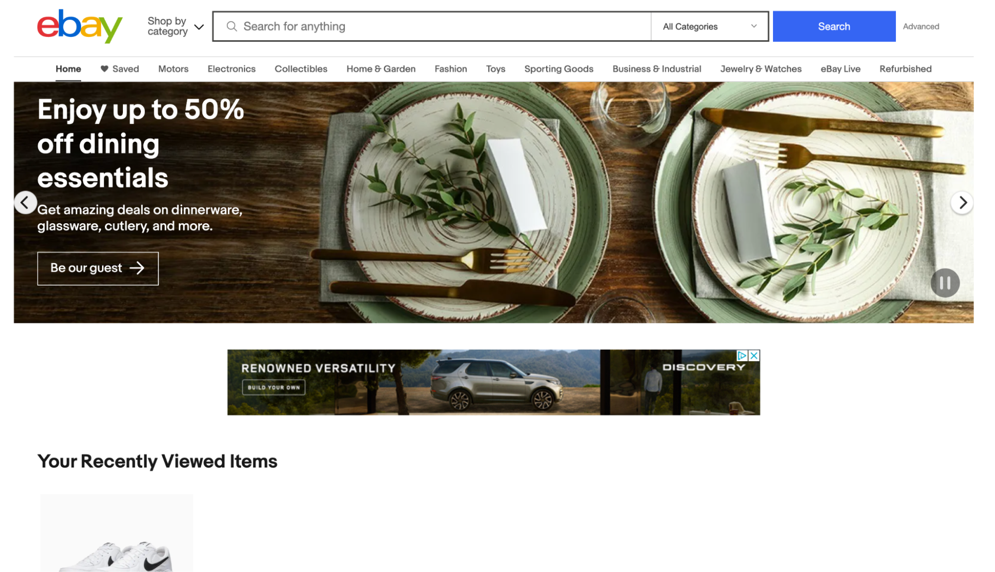 Ebay homepage with banner advertising dining sets, showing gold-rimmed plates, knives, and forks.