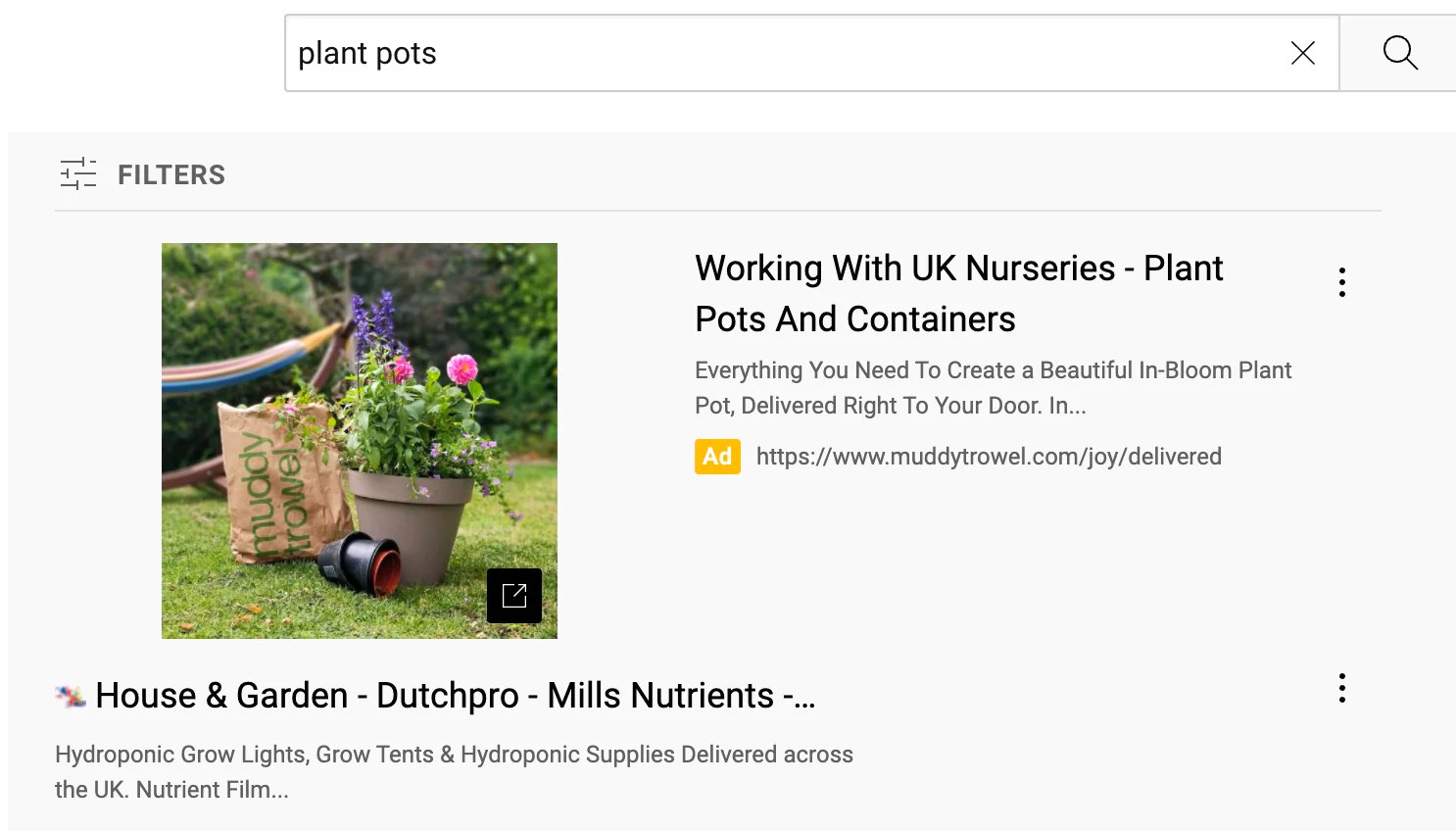 A discovery ad showing a yard with plant pots and flowers in a YouTube results page
