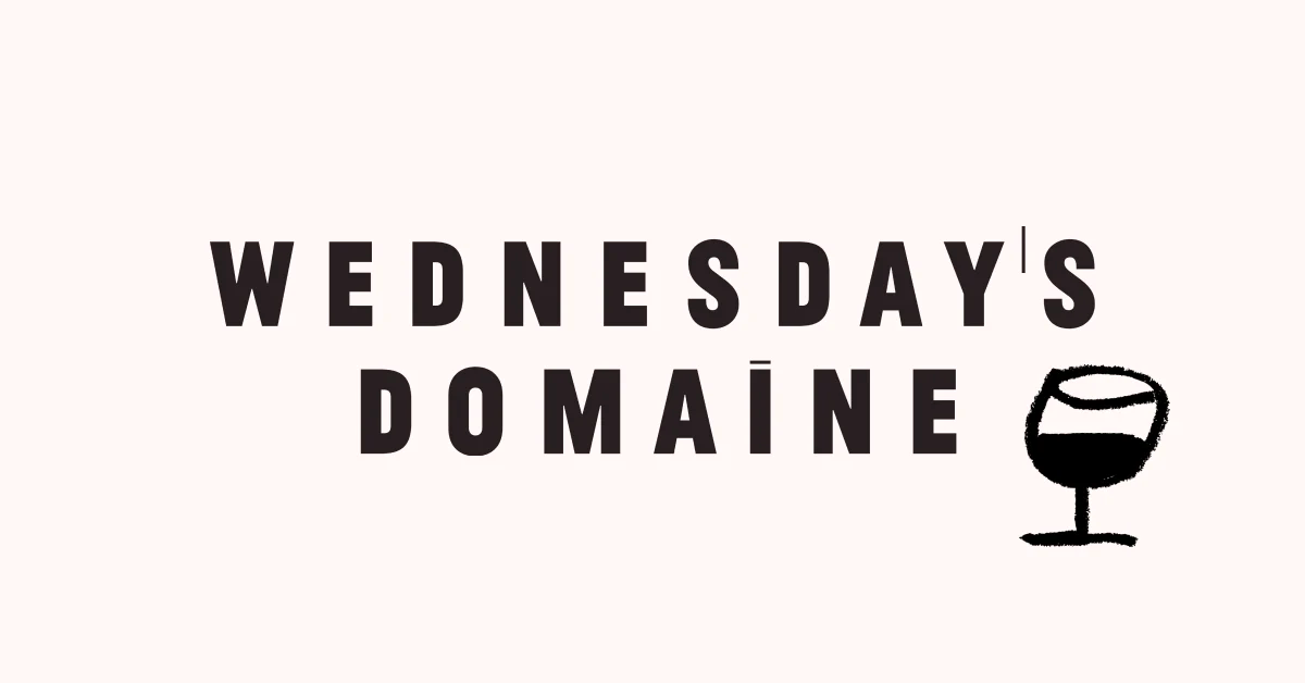 The Wednesday’s Domaine logo includes the brand name and an illustrated drawing of a wine glass filled with wine