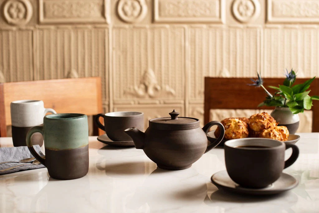 A tea setting complete with cups and a teapot from Jono Pandolfi Designs