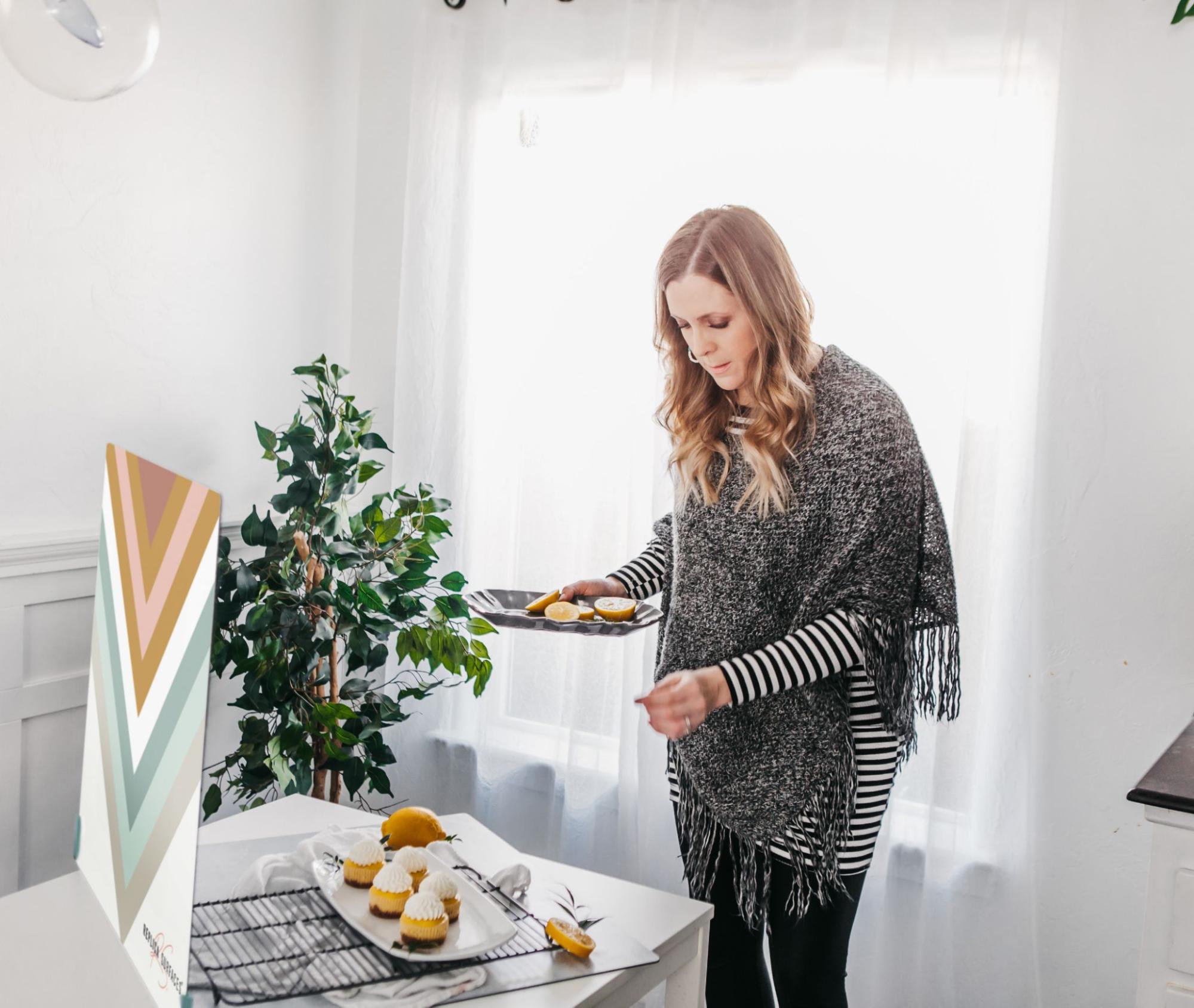 Woman shooting ecommerce photography with a white shower curtain in the background to diffuse light