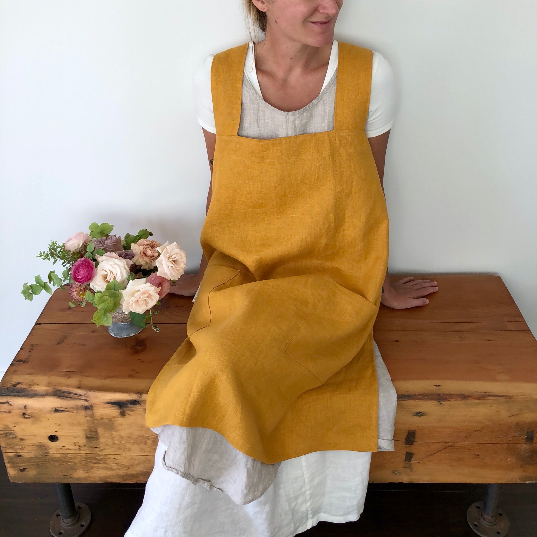 Image of a model wearing a golden yellow apron